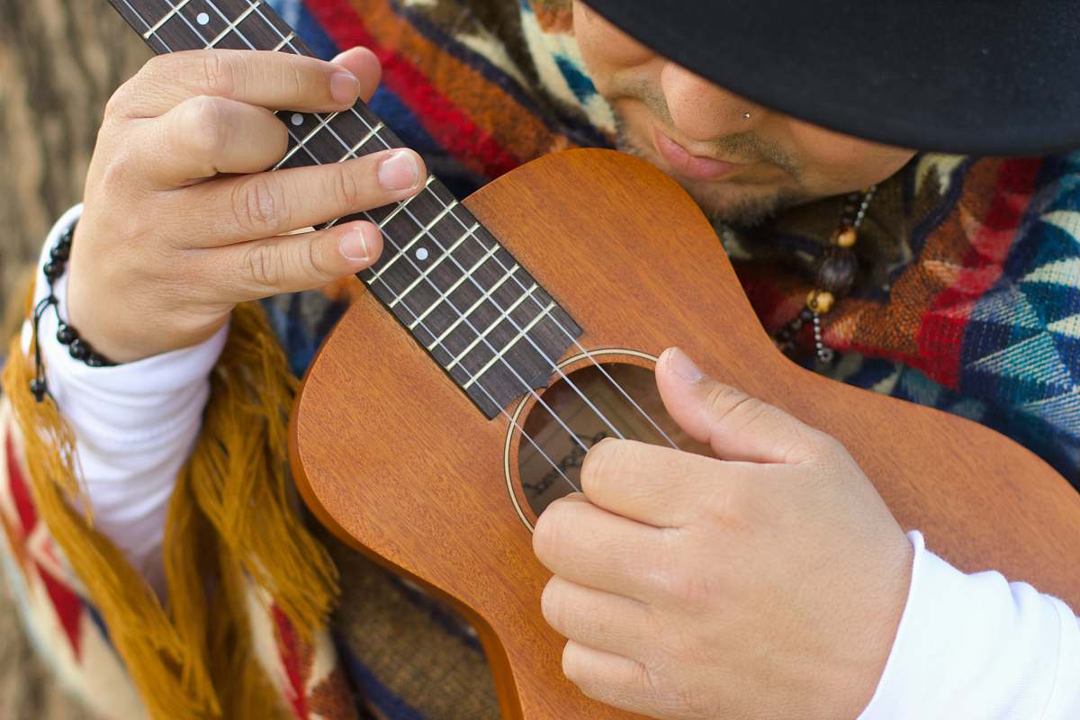 guitar person playing brown ukulele leisure activities